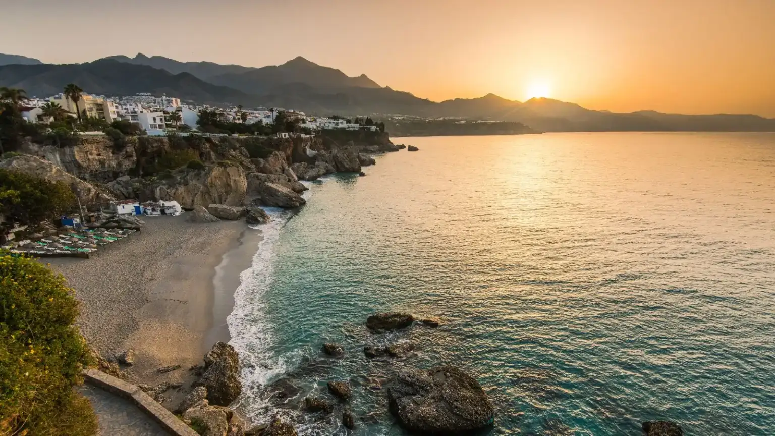 Solicitor Nerja 1 - abogado Nerja, abogado Torrox, abogado Velez Malaga, abogado Torre del Mar The Nerja coastline at sunset, with the cliffs and a calm sea
