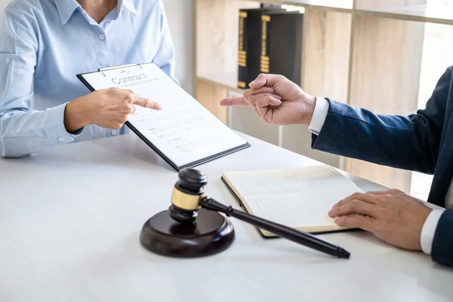 Claiming a company’s debts directly from its director 1 - abogado Nerja, abogado Torrox, abogado Velez Malaga, abogado Torre del Mar businesswoman male lawyers working discussion having law firm office - abogado Nerja, abogado Torrox, abogado Velez Malaga, abogado Torre del Mar